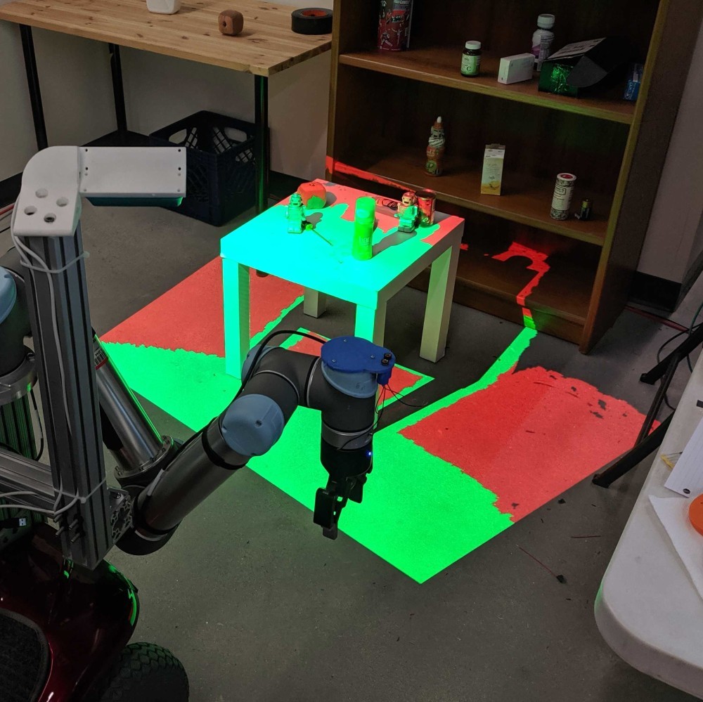 grasp radius Grasp radius visualization through projection mapping. Objects that can be grasped are highlighted green, and objects that are out of reach of the arm are highlighted red.